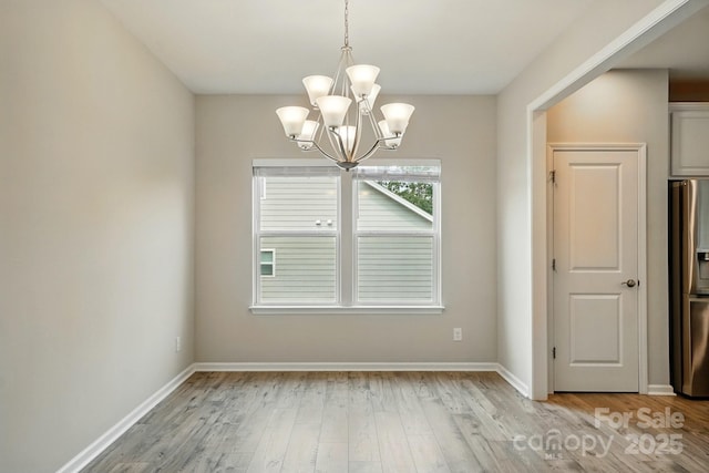 18619 Mainsail Ct, Lancaster, SC 29720 - unfurnished dining area with a chandelier, light wood-style flooring, and baseboards