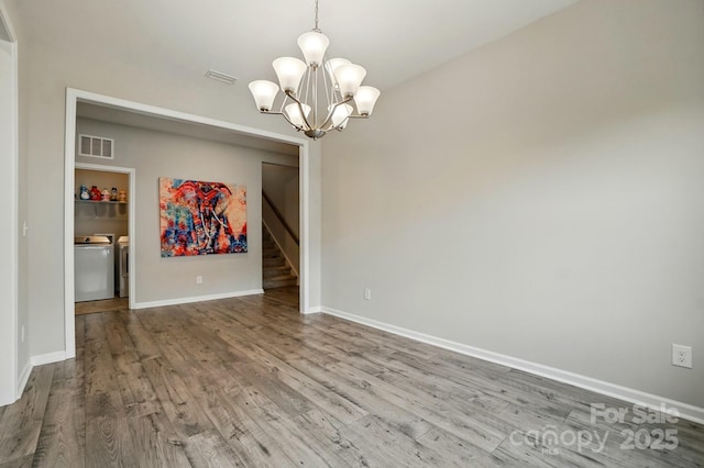 18619 Mainsail Ct, Lancaster, SC 29720 - spare room with separate washer and dryer, wood finished floors, a chandelier, stairway, and baseboards