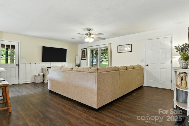5378 Westwood Dr, Granite Falls, NC 28630 - living area featuring plenty of natural light, a ceiling fan, dark wood-style floors, and wainscoting
