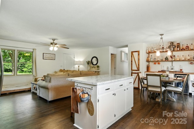 5378 Westwood Dr, Granite Falls, NC 28630 - kitchen with wine cooler, dark wood-type flooring, white cabinets, a ceiling fan, and pendant lighting