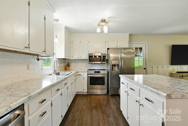 5378 Westwood Dr, Granite Falls, NC 28630 - kitchen with stainless steel appliances, white cabinetry, dark wood-type flooring, decorative backsplash, and a textured ceiling
