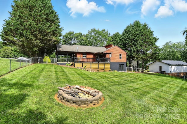 5378 Westwood Dr, Granite Falls, NC 28630 - fenced backyard with a fire pit and a wooden deck