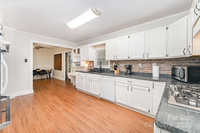 1107 Fairfield Dr, Gastonia, NC 28054 - kitchen featuring stainless steel appliances, white cabinetry, crown molding, light wood finished floors, and decorative backsplash