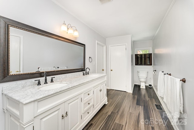 1107 Fairfield Dr, Gastonia, NC 28054 - full bath with double vanity, toilet, ornamental molding, wood finished floors, and baseboards
