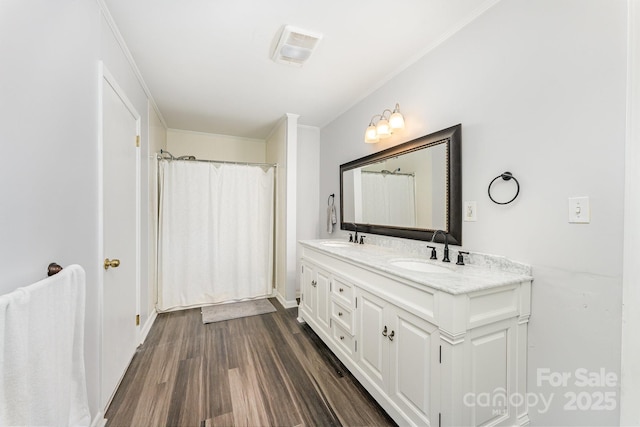 1107 Fairfield Dr, Gastonia, NC 28054 - bathroom featuring double vanity, wood finished floors, ornamental molding, and baseboards