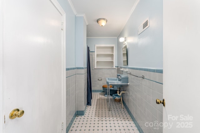 1107 Fairfield Dr, Gastonia, NC 28054 - bathroom with tile walls, curtained shower, crown molding, a wainscoted wall, and tile patterned flooring