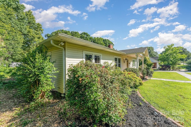 1107 Fairfield Dr, Gastonia, NC 28054 - view of side of home with a lawn and a chimney