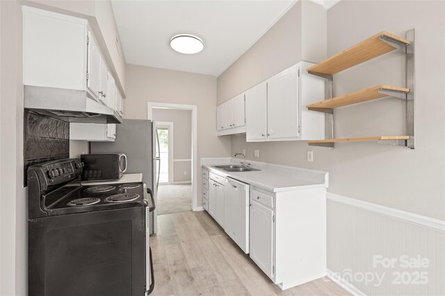 5949 Quail Hollow Rd Unit E, Charlotte, NC 28210 - kitchen featuring black appliances, a sink, light wood-style floors, ventilation hood, and white cabinets