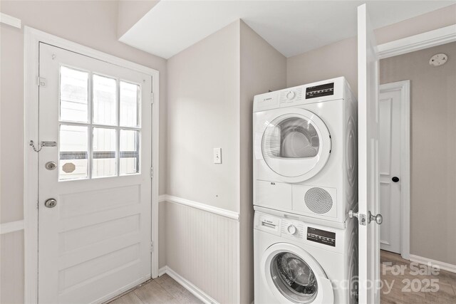 5949 Quail Hollow Rd Unit E, Charlotte, NC 28210 - laundry area with estacked washer and dryer, light wood-type flooring, and wainscoting