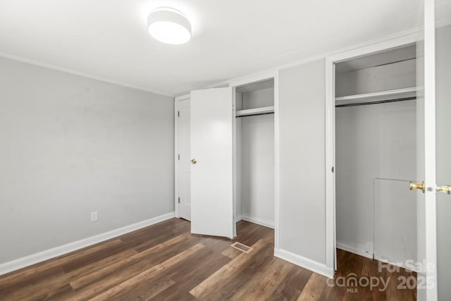 5354 Sherrills Ford Rd, Catawba, NC 28609 - unfurnished bedroom with two closets, dark wood-style flooring, baseboards, and crown molding