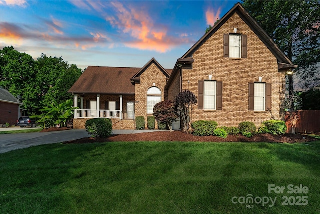 3831 Riceland Pl, Charlotte, NC 28216 - view of front of home with a porch, a lawn, and brick siding