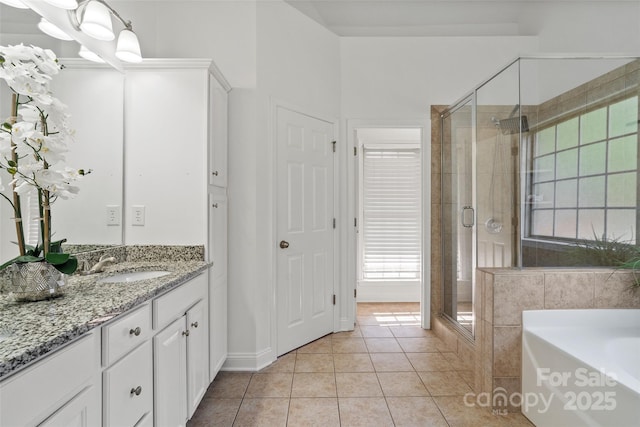 3831 Riceland Pl, Charlotte, NC 28216 - full bathroom featuring vanity, a stall shower, tile patterned flooring, and a bath