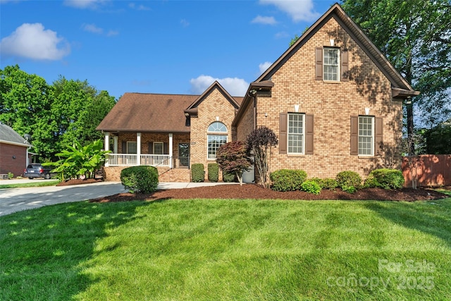 3831 Riceland Pl, Charlotte, NC 28216 - view of front facade featuring covered porch, brick siding, and a front lawn