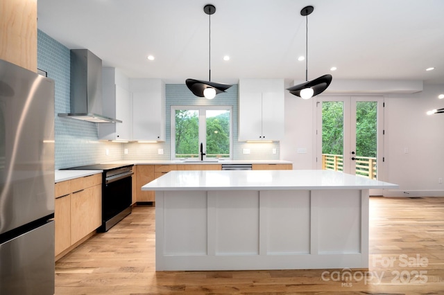 33 Windago Rd, Weaverville, NC 28787 - kitchen with stainless steel appliances, wall chimney exhaust hood, a sink, light countertops, and modern cabinets