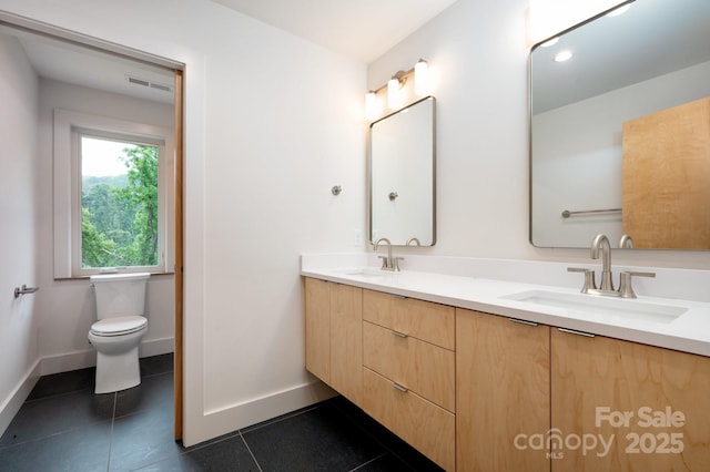 33 Windago Rd, Weaverville, NC 28787 - full bath featuring toilet, double vanity, tile patterned floors, and baseboards