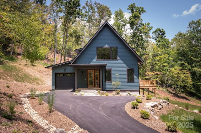 33 Windago Rd, Weaverville, NC 28787 - view of front of home featuring an attached garage, driveway, a wooden deck, and french doors