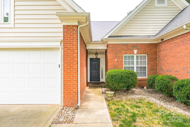 13402 Mccoy Rd, Huntersville, NC 28078 - doorway to property featuring brick siding, a shingled roof, a garage, and driveway