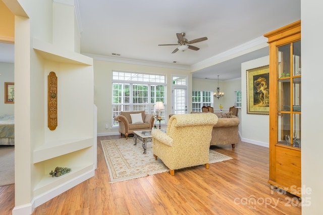 13402 Mccoy Rd, Huntersville, NC 28078 - living room with ornamental molding, wood finished floors, ceiling fan, and a chandelier