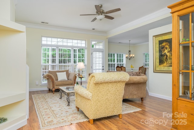 13402 Mccoy Rd, Huntersville, NC 28078 - living area featuring ornamental molding, wood finished floors, a chandelier, and ceiling fan
