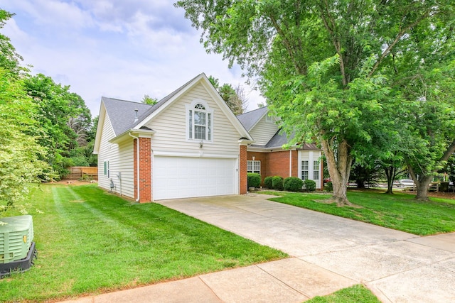 13402 Mccoy Rd, Huntersville, NC 28078 - traditional-style house featuring an attached garage, brick siding, concrete driveway, and a front yard