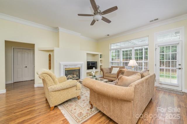 13402 Mccoy Rd, Huntersville, NC 28078 - living room featuring crown molding, wood finished floors, a ceiling fan, and a premium fireplace