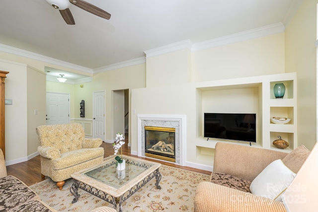 13402 Mccoy Rd, Huntersville, NC 28078 - living area featuring crown molding, ceiling fan, wood finished floors, built in features, and a high end fireplace