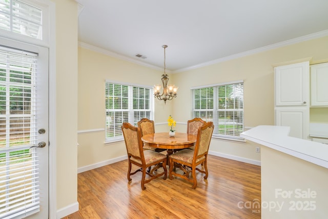 13402 Mccoy Rd, Huntersville, NC 28078 - dining area featuring crown molding, light wood-style floors, and a chandelier