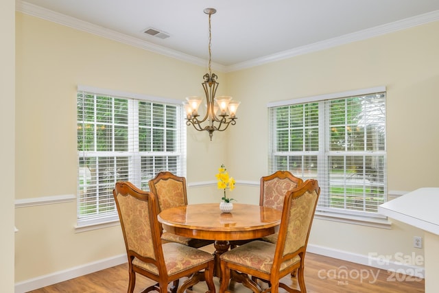 13402 Mccoy Rd, Huntersville, NC 28078 - dining room featuring healthy amount of natural light, ornamental molding, a chandelier, and light wood-type flooring
