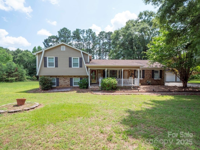 409 Ridge Rd, Clover, SC 29710 - split level home featuring covered porch, a front lawn, brick siding, and an attached garage