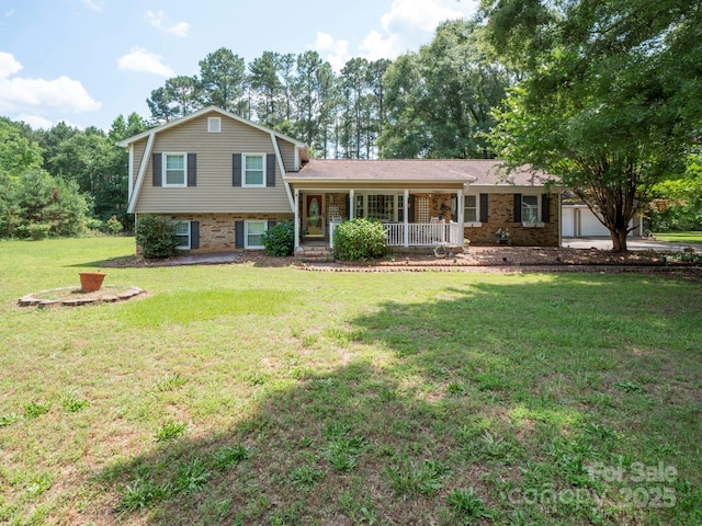 409 Ridge Rd, Clover, SC 29710 - tri-level home with a porch, a front lawn, a garage, and brick siding