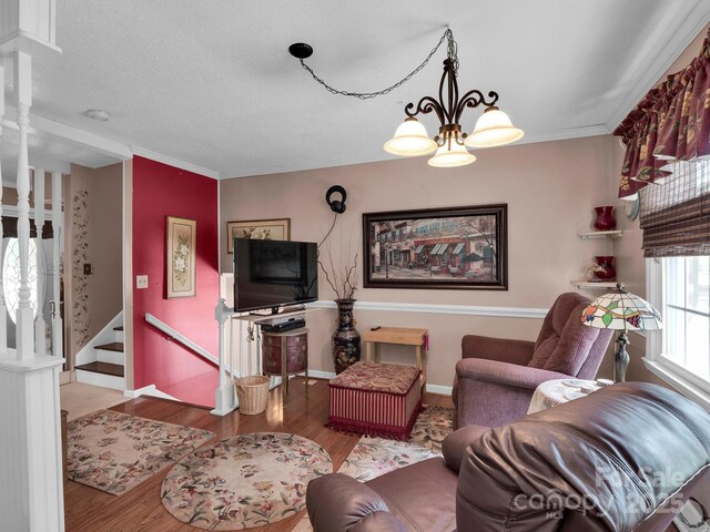 409 Ridge Rd, Clover, SC 29710 - living room with baseboards, wood finished floors, stairs, a chandelier, and crown molding