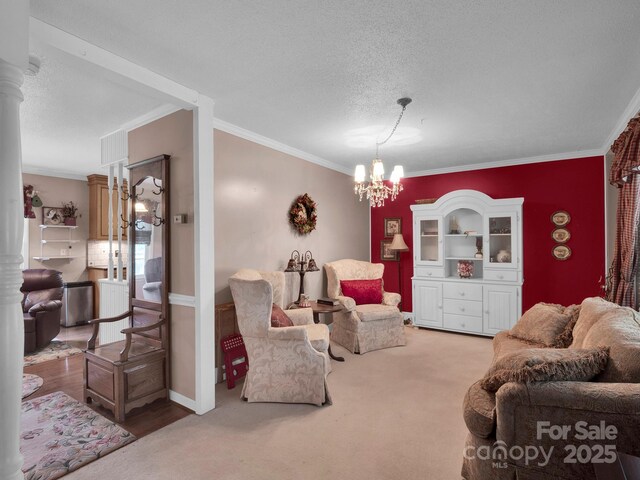 409 Ridge Rd, Clover, SC 29710 - living area featuring crown molding, a chandelier, a textured ceiling, ornate columns, and carpet flooring