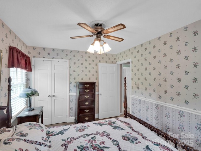 409 Ridge Rd, Clover, SC 29710 - bedroom featuring wallpapered walls, a closet, a ceiling fan, and wainscoting