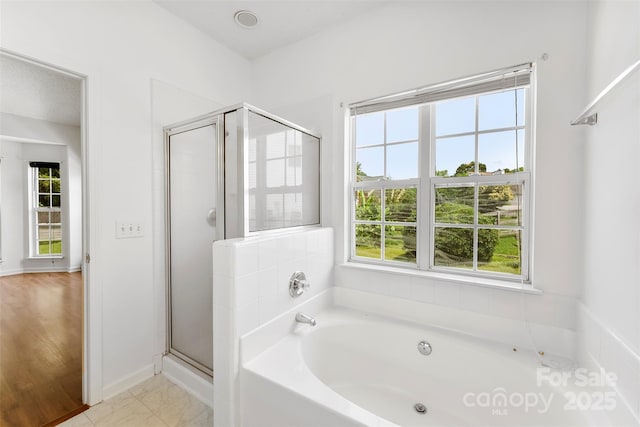 13832 Queenswater Ln, Charlotte, NC 28273 - bathroom featuring plenty of natural light, a garden tub, a shower stall, and baseboards