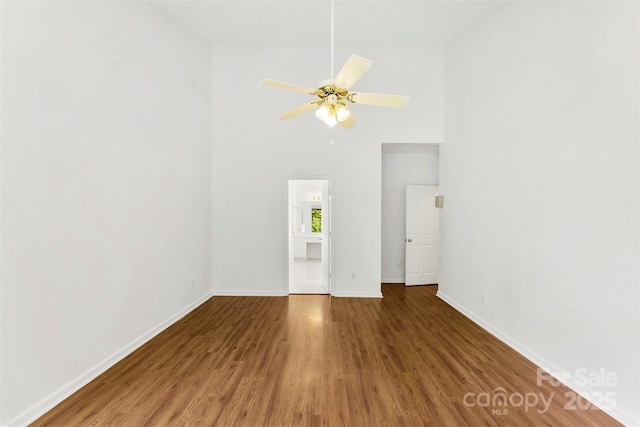 13832 Queenswater Ln, Charlotte, NC 28273 - unfurnished living room with wood finished floors, baseboards, ceiling fan, and a high ceiling