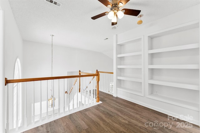 13832 Queenswater Ln, Charlotte, NC 28273 - hallway with an upstairs landing, wood finished floors, built in features, a chandelier, and a textured ceiling