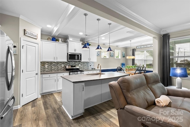 5059 Fenwick Ct, Lancaster, SC 29720 - kitchen with open floor plan, appliances with stainless steel finishes, ornamental molding, decorative backsplash, and dark wood-style flooring