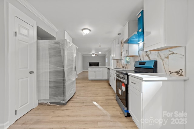 4918 Tyne Dr, Durham, NC 27703 - kitchen with appliances with stainless steel finishes, a sink, white cabinetry, ceiling fan, and light wood-style flooring