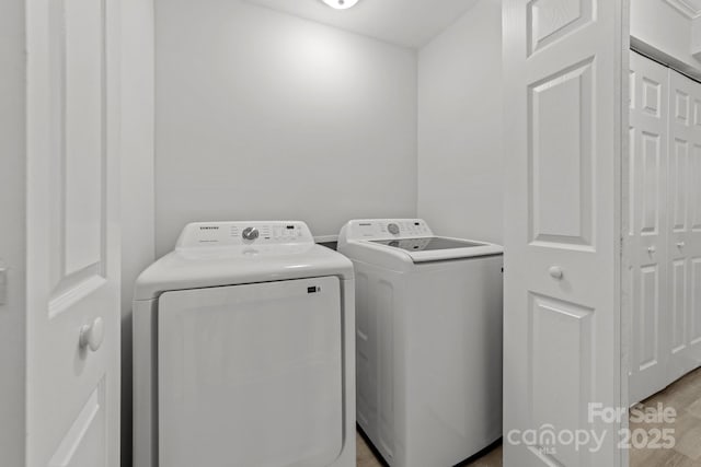 4918 Tyne Dr, Durham, NC 27703 - laundry area with washing machine and dryer and light wood-style floors