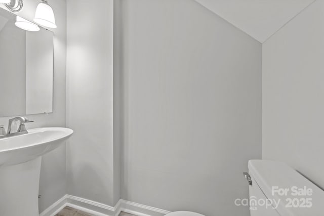 4918 Tyne Dr, Durham, NC 27703 - half bathroom with toilet, baseboards, and a sink
