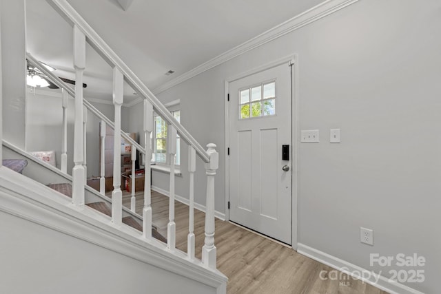4918 Tyne Dr, Durham, NC 27703 - entryway featuring wood finished floors, stairway, baseboards, and ornamental molding