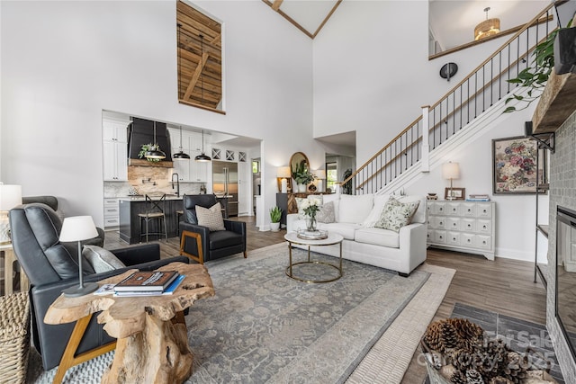 5888 Wood Duck Way, Catawba, NC 28609 - living room featuring a towering ceiling, stairway, and dark wood-style floors