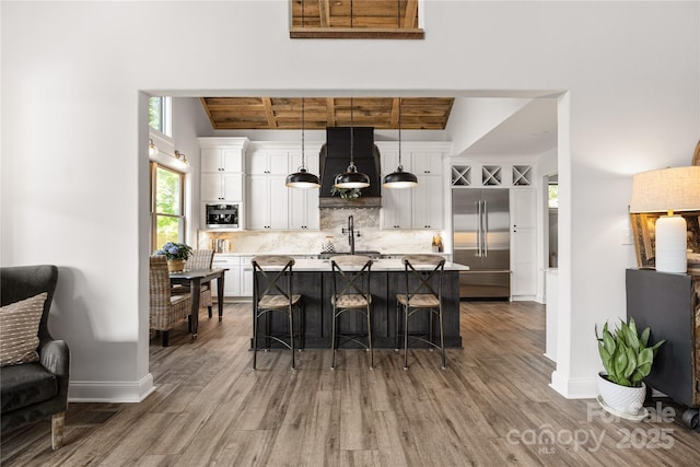5888 Wood Duck Way, Catawba, NC 28609 - kitchen featuring built in fridge, range hood, dark wood-type flooring, tasteful backsplash, and light countertops