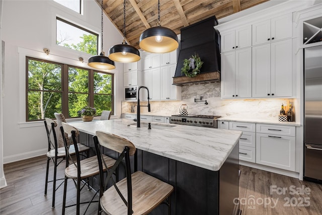 5888 Wood Duck Way, Catawba, NC 28609 - kitchen featuring a wooden ceiling with exposed beams, built in fridge, premium range hood, an island with sink, and decorative backsplash