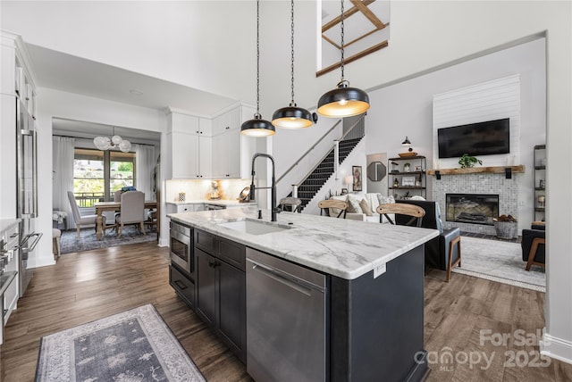 5888 Wood Duck Way, Catawba, NC 28609 - kitchen with stainless steel appliances, white cabinets, a chandelier, dark wood-type flooring, and a center island with sink