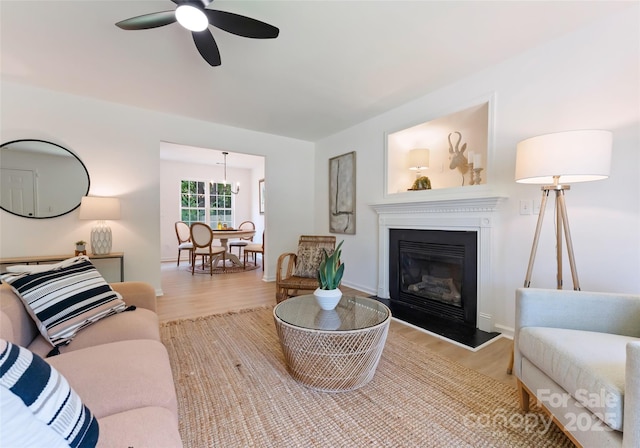 5229 Tarrywood Ln, Charlotte, NC 28205 - living room with a ceiling fan, wood finished floors, a glass covered fireplace, and baseboards