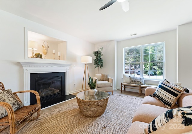 5229 Tarrywood Ln, Charlotte, NC 28205 - living room featuring wood finished floors, a glass covered fireplace, a ceiling fan, and baseboards