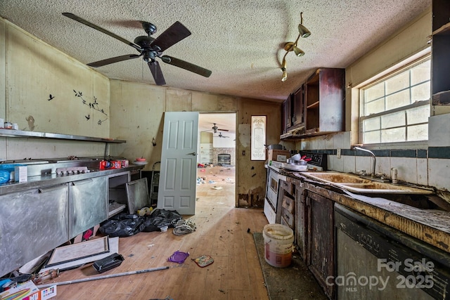 99 Bridges Cove Rd, Leicester, NC 28748 - kitchen featuring electric range, dishwashing machine, a ceiling fan, light wood-type flooring, and a textured ceiling