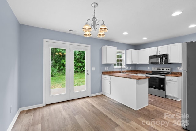 120 Alpine Ridge Dr, Asheville, NC 28803 - kitchen with stainless steel appliances, dark countertops, white cabinetry, a chandelier, and recessed lighting