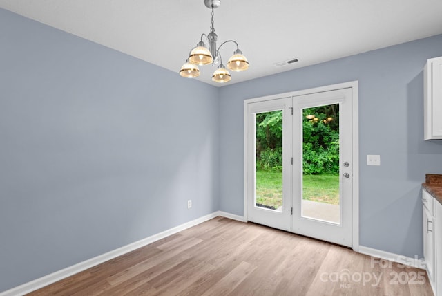 120 Alpine Ridge Dr, Asheville, NC 28803 - unfurnished dining area with a chandelier and light wood-style flooring